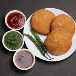 Indian snakes food kachouri or kachoudi kachori served with tamarind and mint chutney